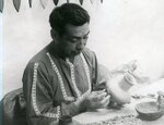 Native American man works on pottery