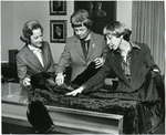 Roberta Church examining her grandmother's coat, 1980