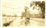 Automobiles travelling on a flooded road, Memphis, 1927