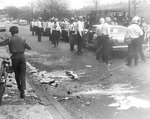 Debris-strewn Memphis street following riots, 1968